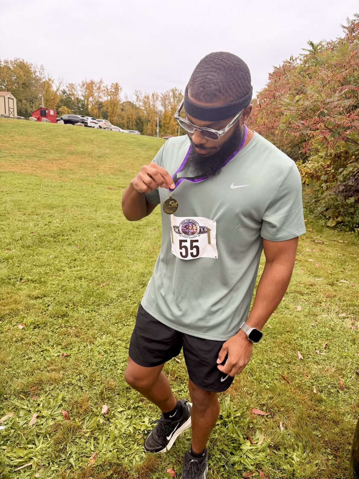 Harrison wearing bib 55 and his medal after the Race for Goals 5K